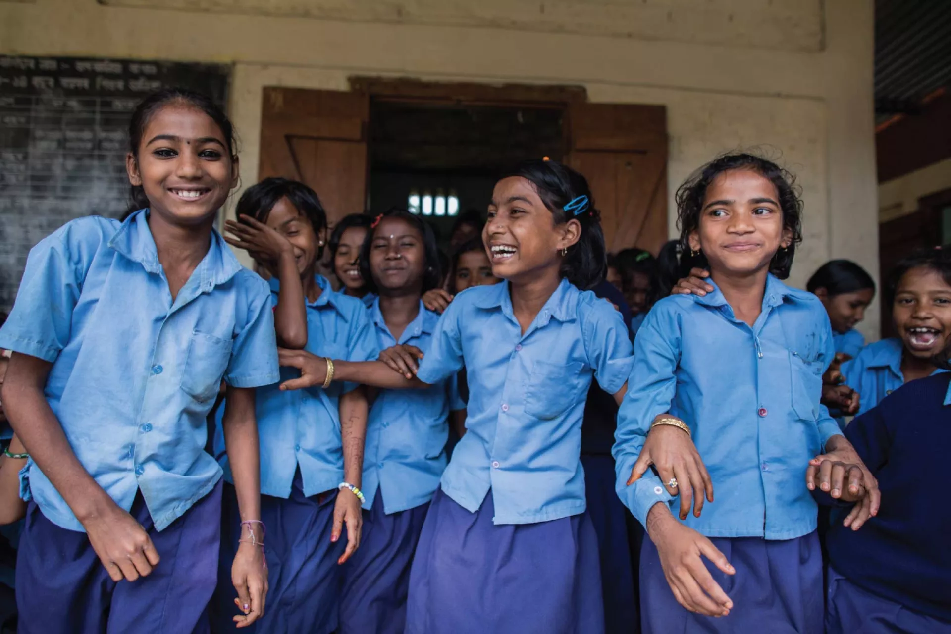 A group of students in a school in India smiling together